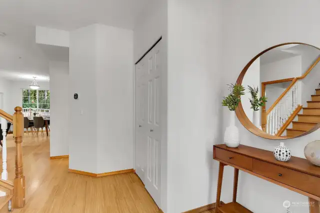 Pleasant entrance with warm bamboo flooring, space for an entry table and double door entry closet
