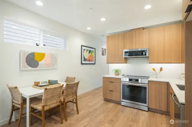 Quartz Countertops, Stainless appliances, gull height tile backsplash, under cabinet lighting!  Photo is of same floorplan.  Color schemes vary by location.