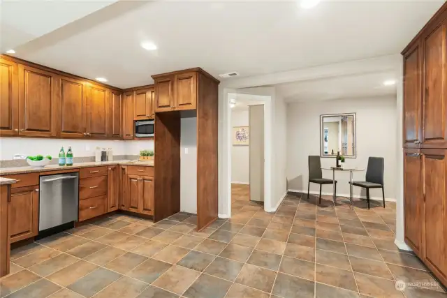 The lower-level kitchenette has a large sink, dishwasher, microwave, fridge space, and amazing storage.