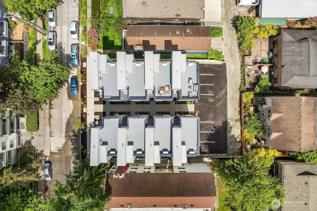 An aerial view from above, showcases an impressive footprint of the home, along with an incredible rooftop deck.