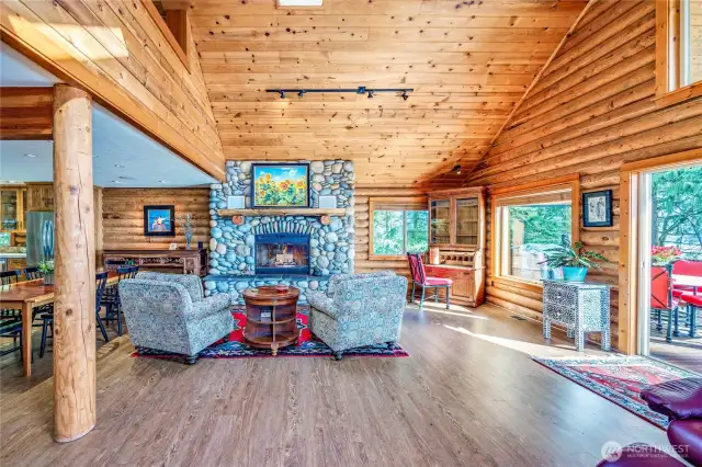The great room is anchored by a stunning faux river rock wood fireplace w/a beautiful wood mantel and hearth.