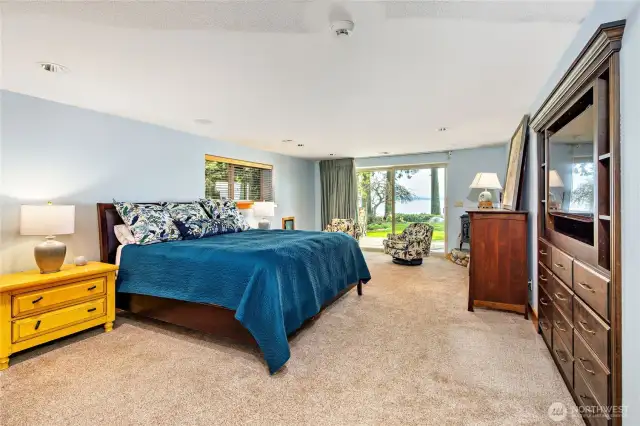 The spacious primary ensuite has a walk-out slider, built-in dresser and a door to the fenced dog run.