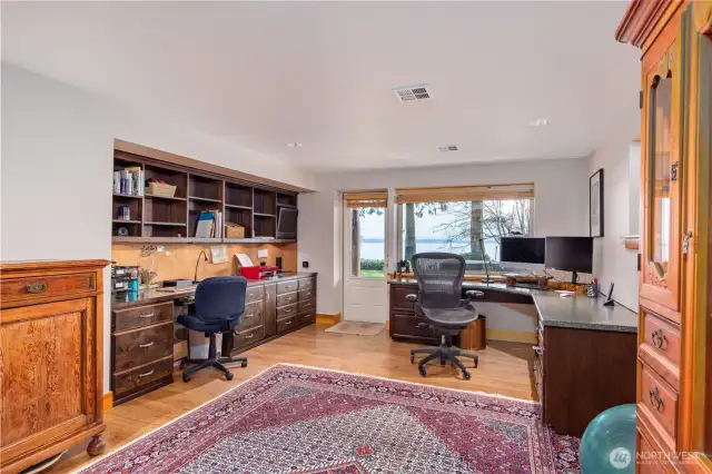 You'll love the full-on views in this beautiful den, and the built-in cabinets, desk space and access to the patio.