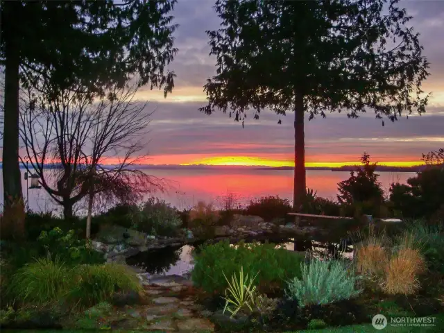 The stunning sunrise over Admiralty Inlet and the Cascade Mountain range in the distance. Note the pond in the foreground.