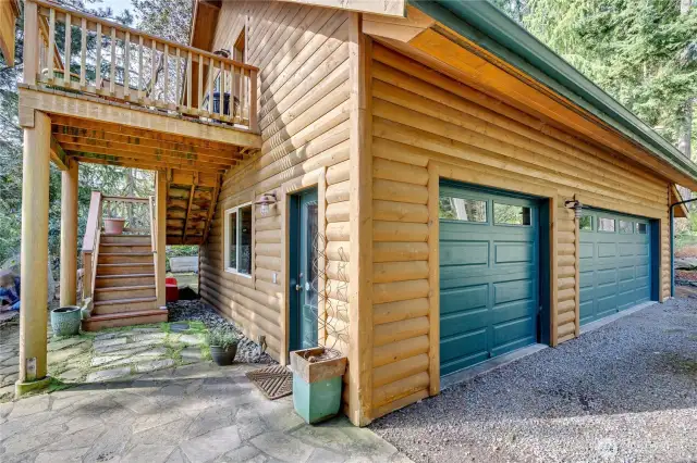 Huge 3-car garage also has a fantastic work shop by the lower side door. Stairs lead to the 1-bedroom apartment.