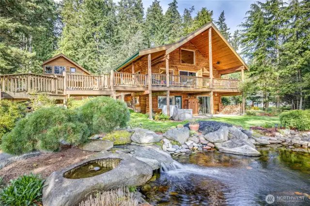 3-car garage and Studio above on the right, main house on left. Stunning waterfall ends in the reciculating pond.