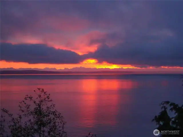 A glorious sunrise over the calm waters of Puget Sound and Cascade mountains. This is truly a stunning home.