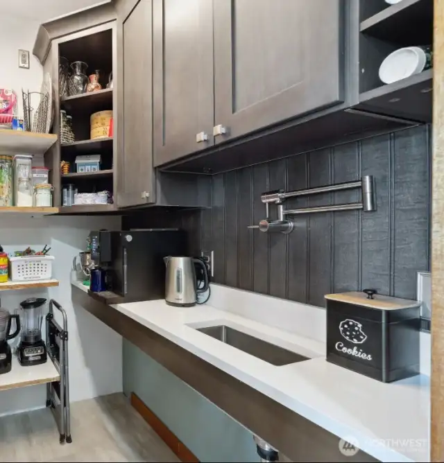 Walkin pantry adjacent to kitchen and YES! that is a built in coffee bar and sink