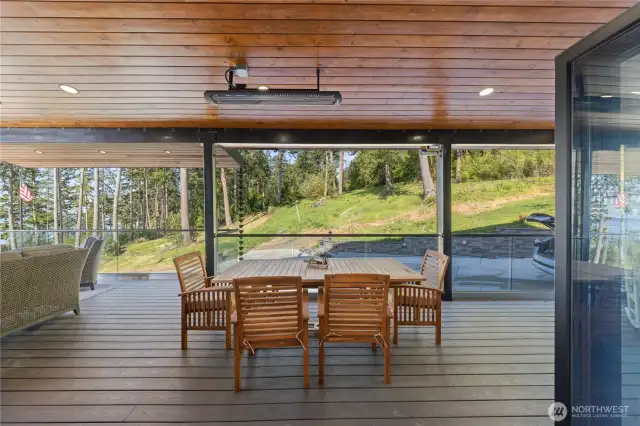 The dining room flows directly to the covered deck with ceiling heaters