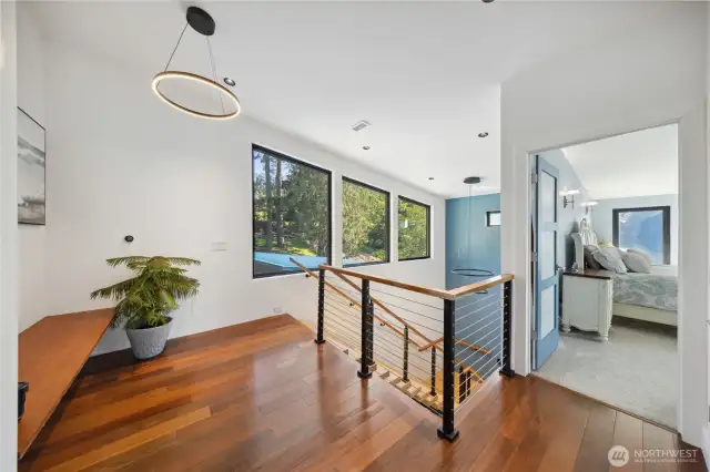 Upper level landing with exotic woods, large windows