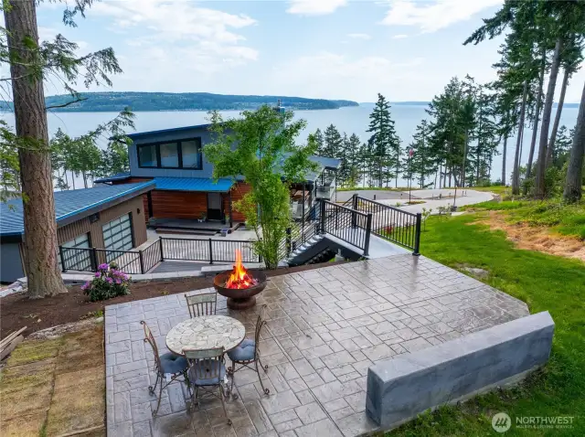 Upper level patio with views to the south of Saratoga Passage.  Full staircase.  Don't miss the large detached garage with over 800 feet of space with an electric car charger
