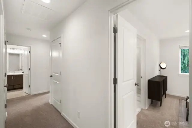 looking down the hall at the primary bedroom and the remaining rooms -- great privacy with separated spaces