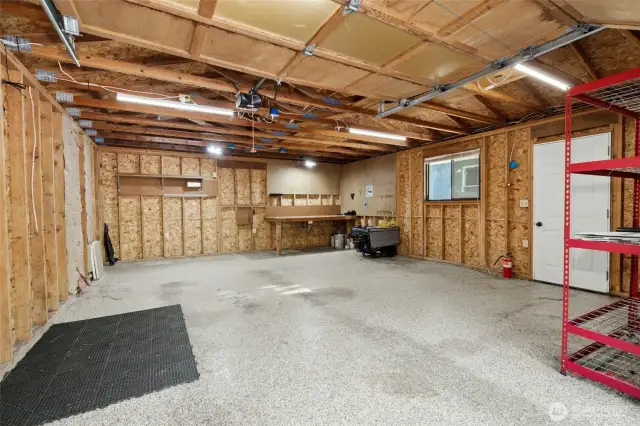 Spacious Garage with custom epoxy flooring