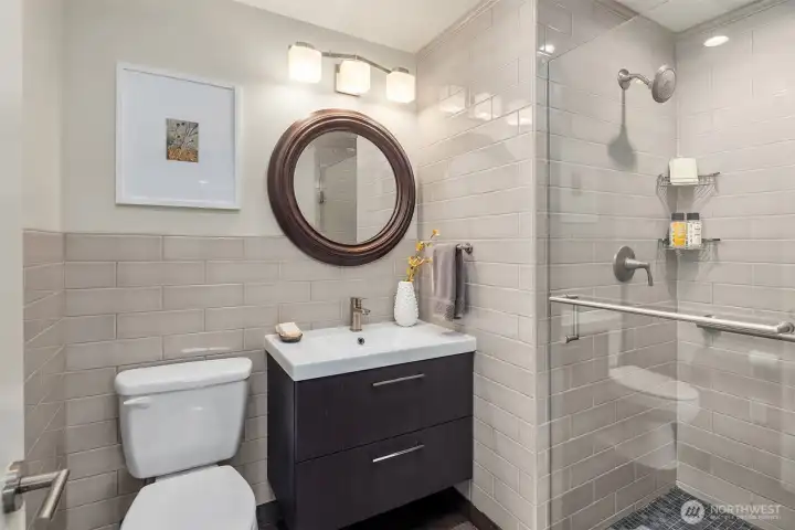Primary bathroom with floating cabinet, heated tile floor and gorgeous shower.