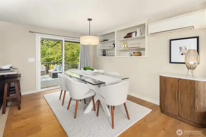 Large dining area with built in shelving and slider to deck.
