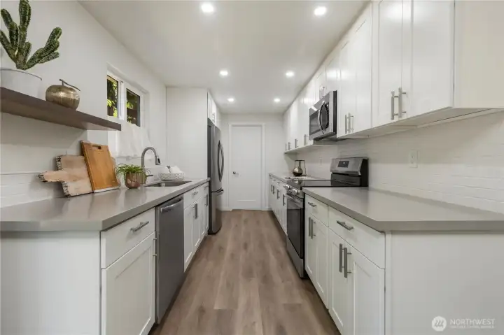 Brilliant remodeled kitchen with new quartz countertops, cabinetry and appliances.
