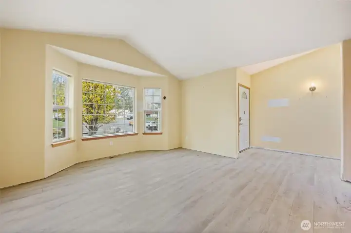 Living room with bay window and entryway.