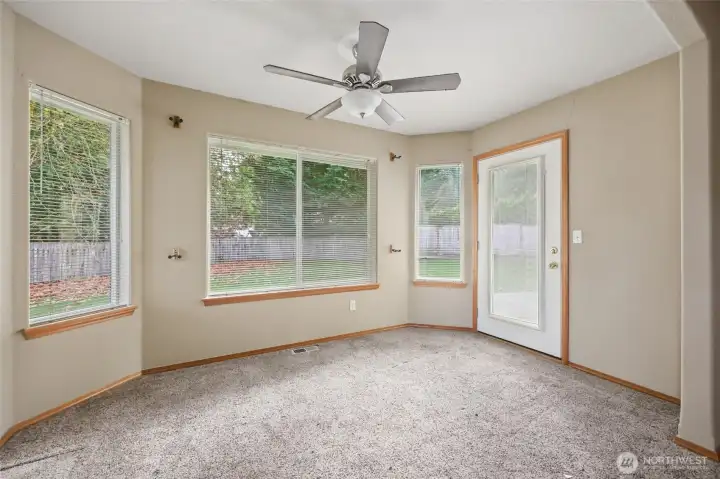 Sitting area of primary bedroom suite with door to patio.