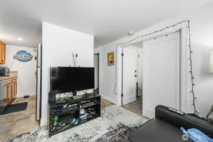 Basement unit living room and kitchen on the left & bedroom on the right.