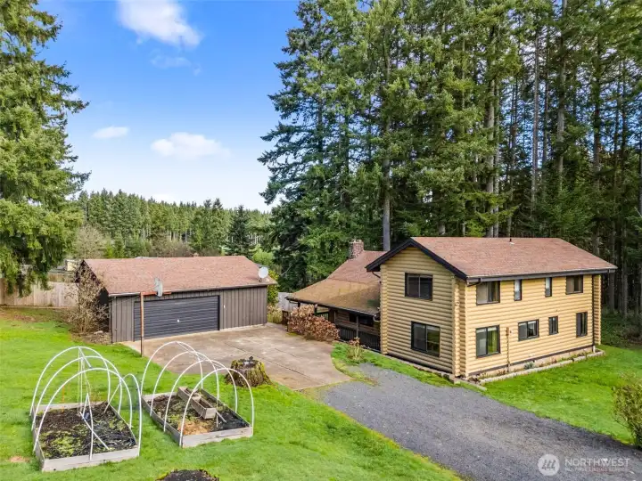 Beautiful log home tucked among the trees with timeless character and a picture-perfect exterior. A brand-new roof on both the home and garage is included in the list price, offering lasting protection and added peace of mind — it’s more than a home, it’s a way of life.