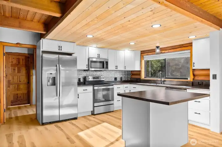The large stainless-steel sink and included appliances make meal prep easy.