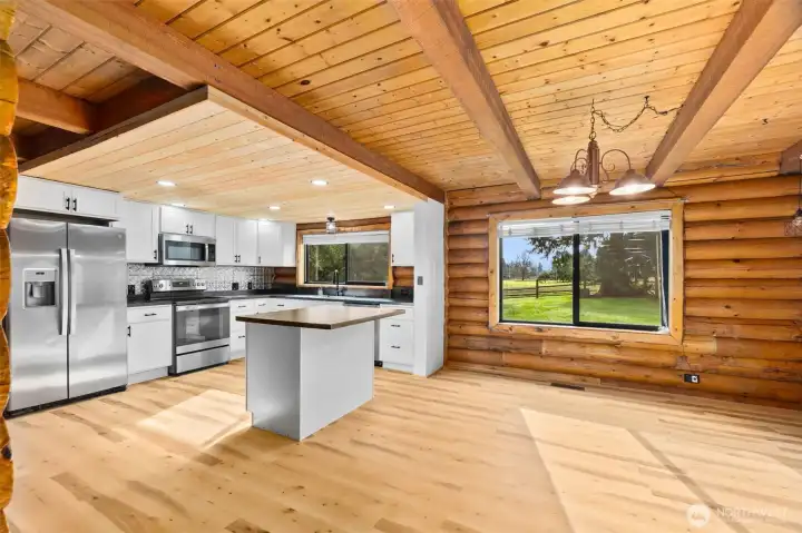 Bright dining room with expansive window views and seamless access to the covered back porch — perfect for entertaining.