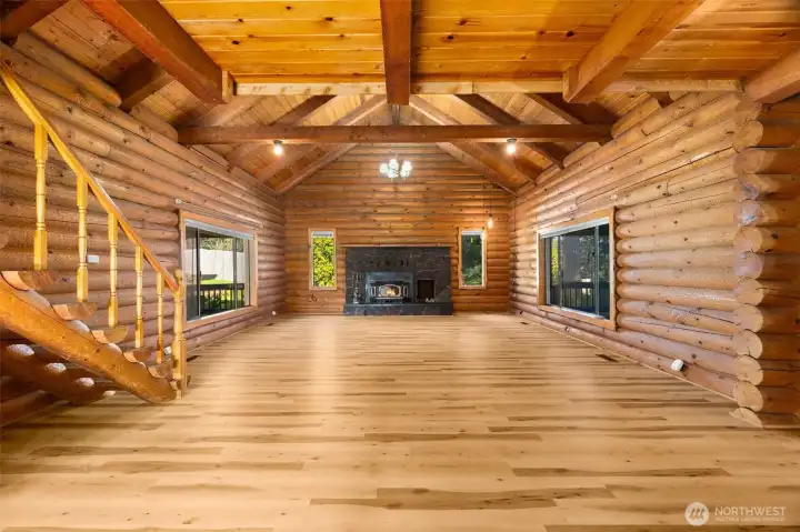 Vaulted ceilings and exposed logs create an inviting great room where memories are made.