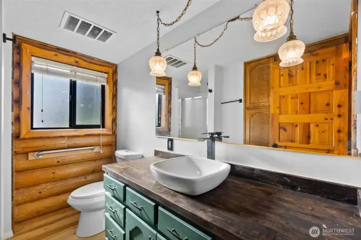 Convenient main-level ¾ bath featuring an updated sink and faucet, adding a touch of luxury.