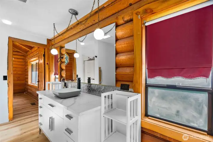 Natural light, a new white vanity, and light countertops create a bright and refreshed upstairs bath.
