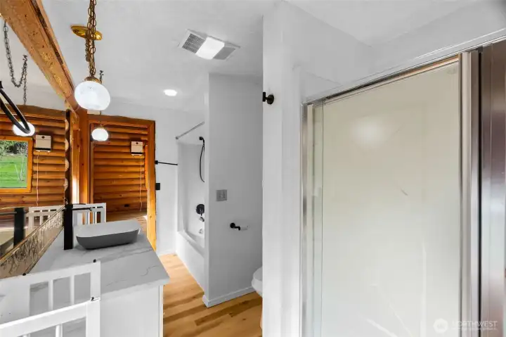 Full bath featuring a second shower for added functionality.