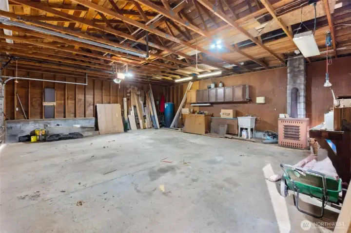 Garage interior - Oversized garage with built-in workspace — perfect for projects, tools, and creativity. (some personal items virtually removed).