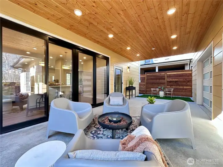 Double sided covered patio breezeway connects garage and main home. Beautiful wood paneled ceiling and plenty of light for extended entertaining.