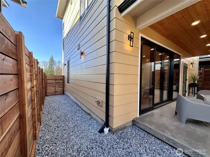 Easy maintenance backyard with turf and rockscape.