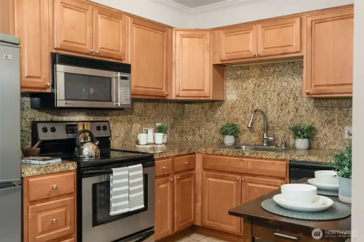 Warm kitchen with stainless appliances Warm kitchen with stainless appliances