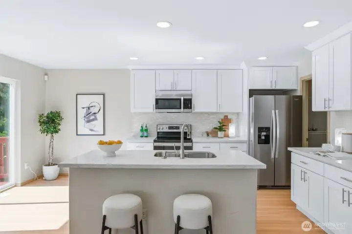 Recent updated kitchen with crisp white cabinetry offers timeless style and abundant storage.
