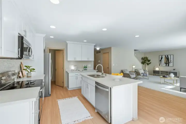 Stylish kitchen flows seamlessly into the family room and casual dining area.