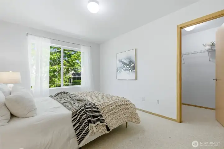 Sun flooded bedroom with a walk-in closet.