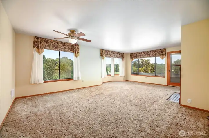 Living room dining room that is filled with natural light with all the windows. Living room dining room that is filled with natural light with all the windows.