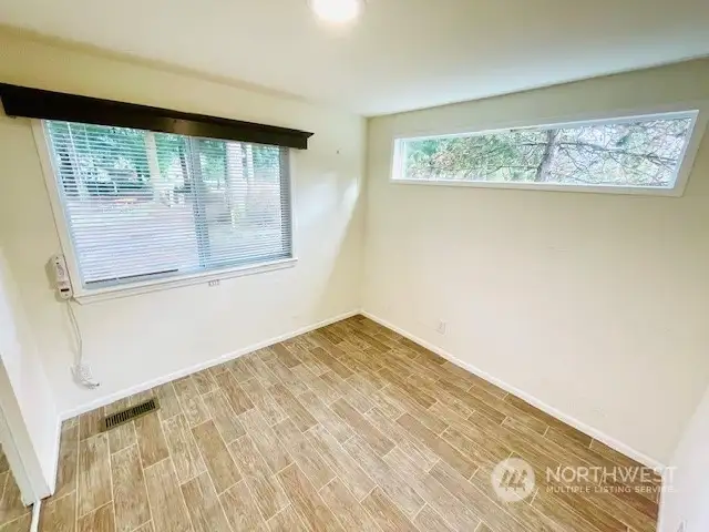 Main floor bedroom with lots of natural light and built-in storage.