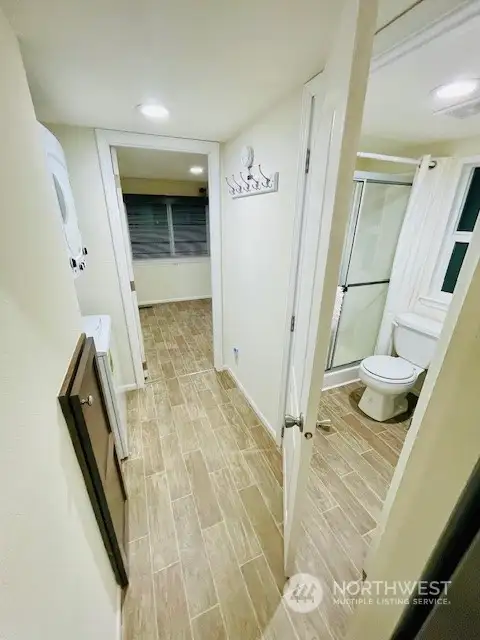 Hallway has ample storage under stairs , bathroom entry and Washer/Dryer.