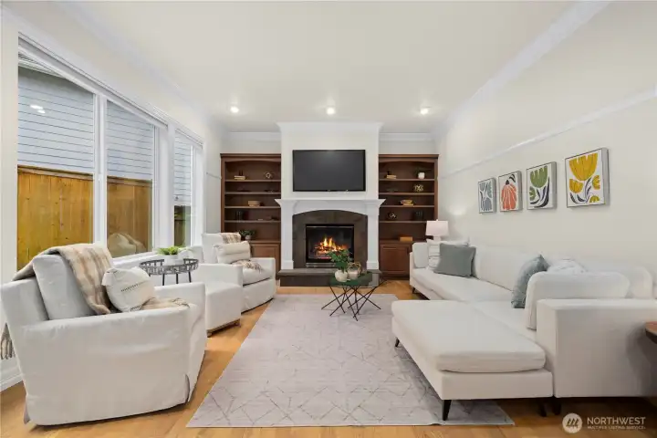 Opposite of the kitchen is the family room. An additional fireplace, bookshelves and views of the backyard.