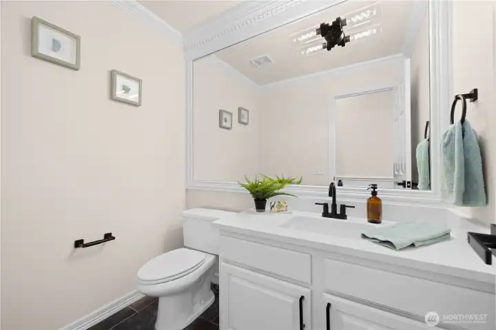Powder room (1/2 bath) on the lower level near garage entrance.