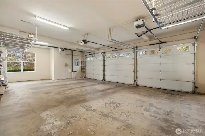 Oversized three car garage has plenty of space and custom built upper storage racks.