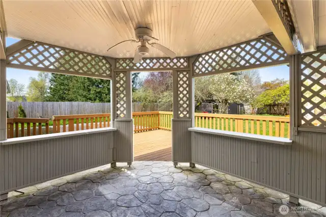 Covered patio with ceiling fan and access to the yard, deck and patio.