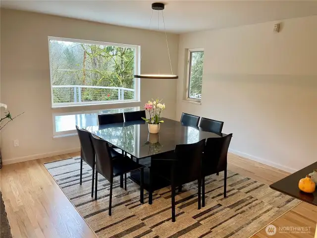 The dining room, adjacent to the kitchen, includes a custom dining table that stays with the home.
