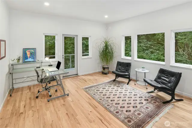 A well-appointed office with direct access to the outdoor deck.