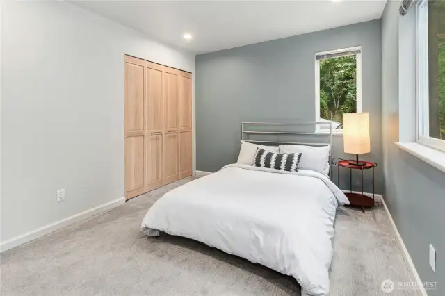 Spacious secondary bedroom, offering peaceful nature views.