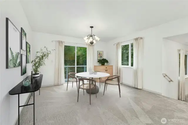 Lower-level dining room, adjacent to the kitchen, flows effortlessly to the covered outdoor deck.