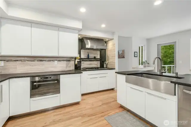 The chef’s kitchen is the heart of the home, featuring a gorgeous oversized island, stainless steel appliances, and honed granite countertops—perfect for cooking and entertaining.