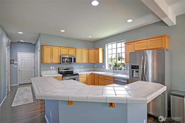 A view of the kitchen upon entering from the living dining room area.